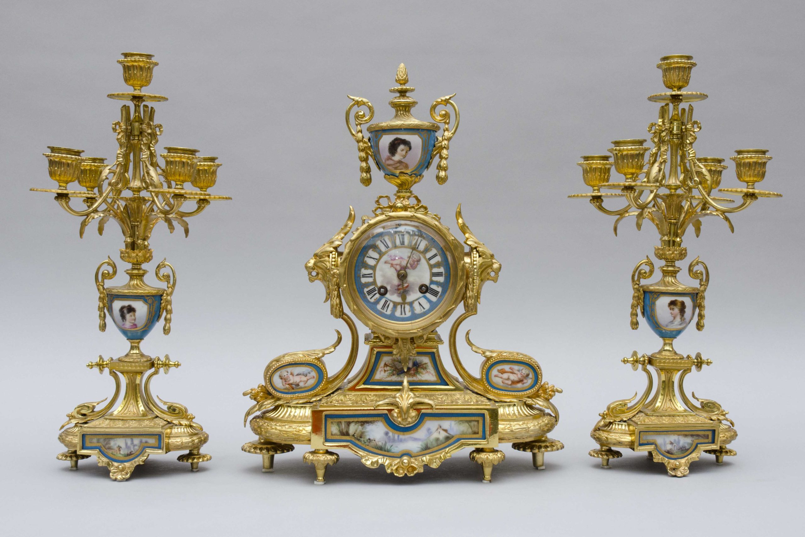 A small Sevres porcelain and gild bronze mantel garniture