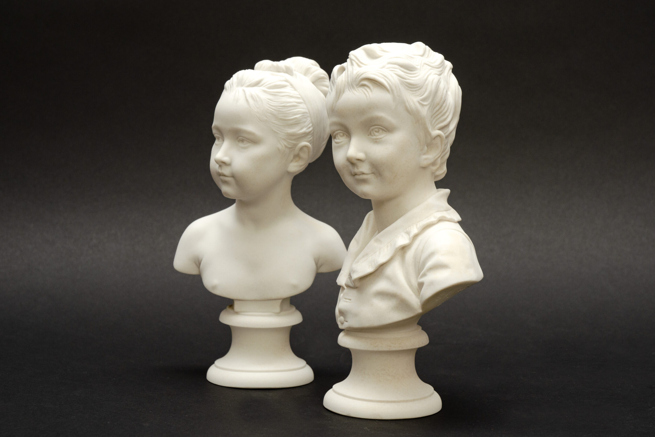 Pair of children’s busts, ‘Alexandre and Louise Brongniart’, after Houdon, Sèvres biscuit porcelain